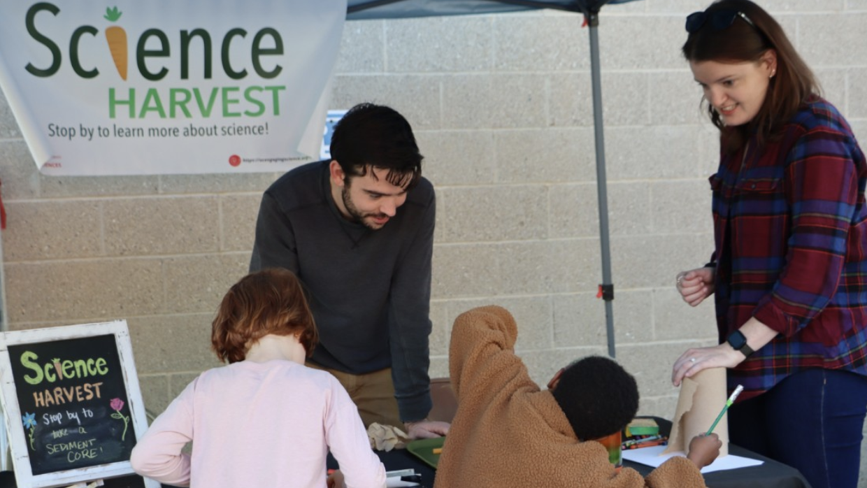 Kids engage with a geosciences sediment project at Northside Farmers Market.