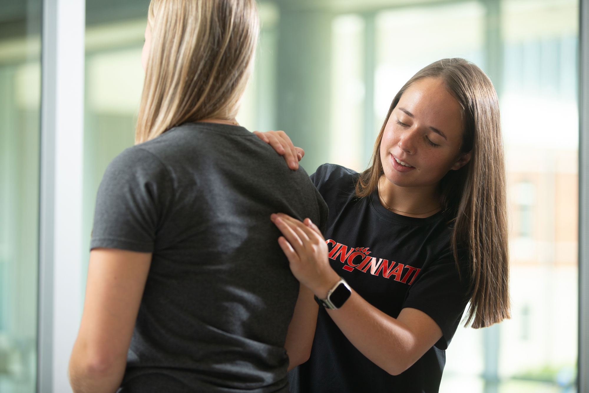 A University of Cincinnati physical therapy student assists a patient