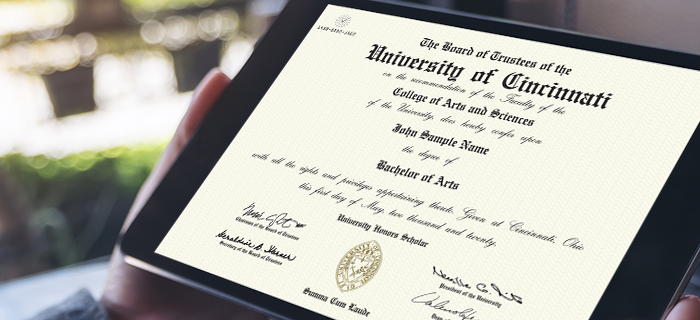Hands holding tablet that displays a CeCredential from the University of Cincinnati's College of Arts and Sciences.