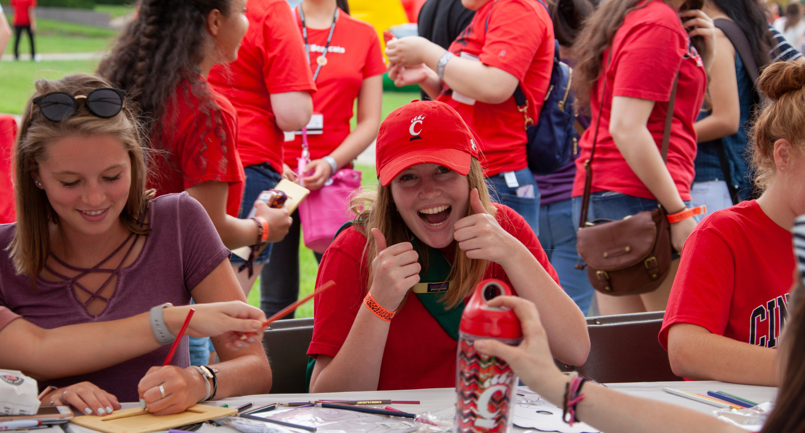 Student at table with an activity and giving a thumbs up