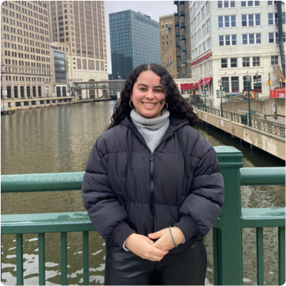female student posing on a bridge