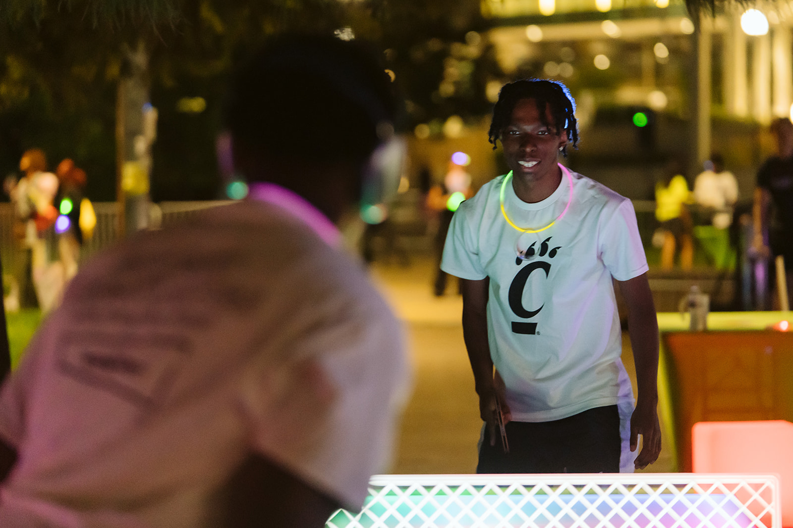 UC students play glow ping pong
