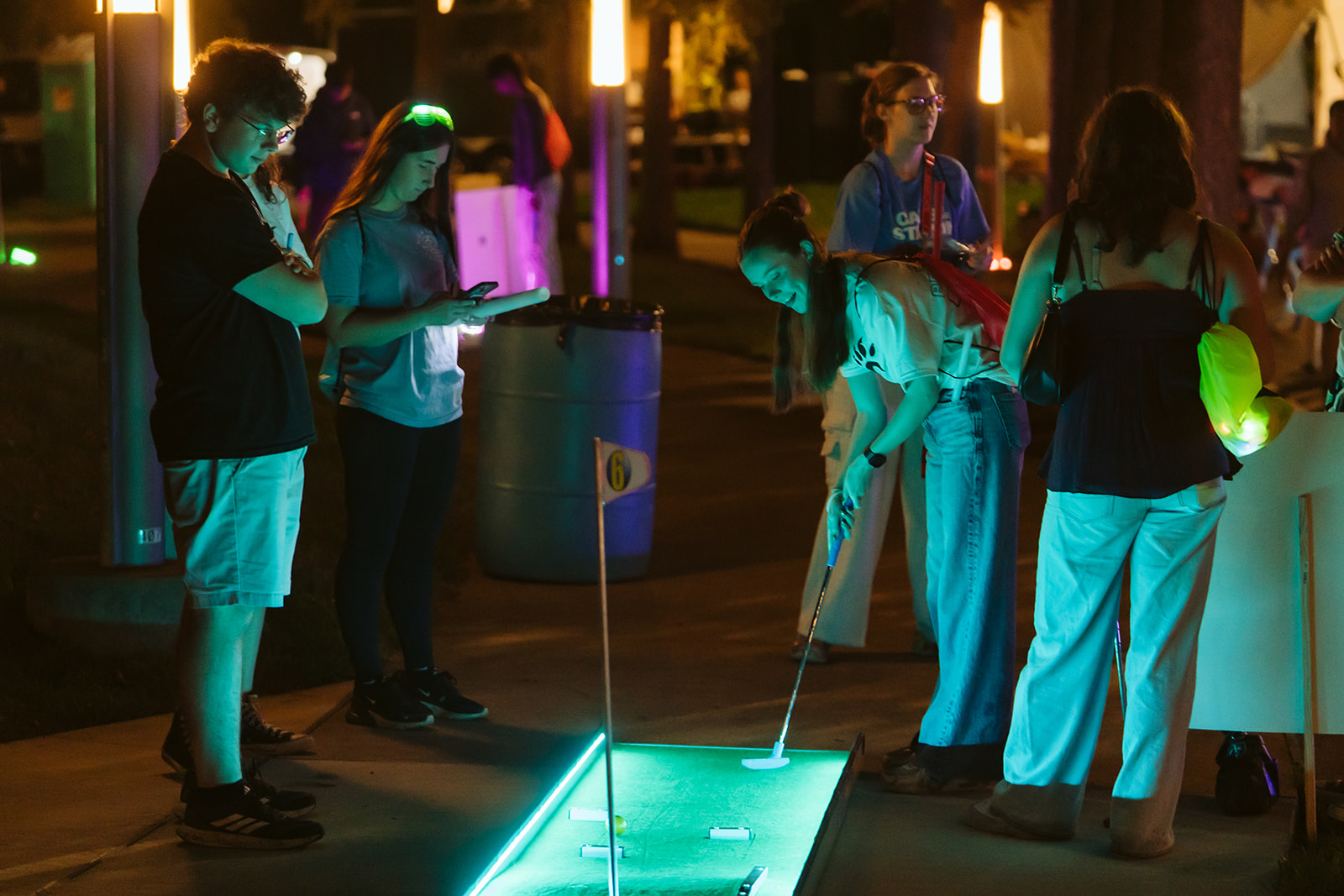 UC students play glow mini golf