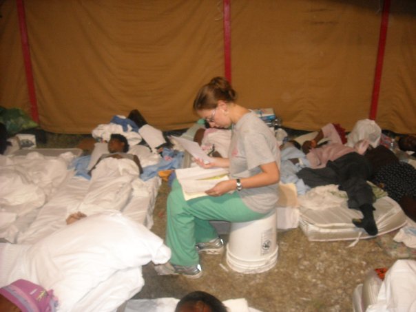 Randi Bates shown attending several people laying on mattresses in an overnight shelter in Haiti
