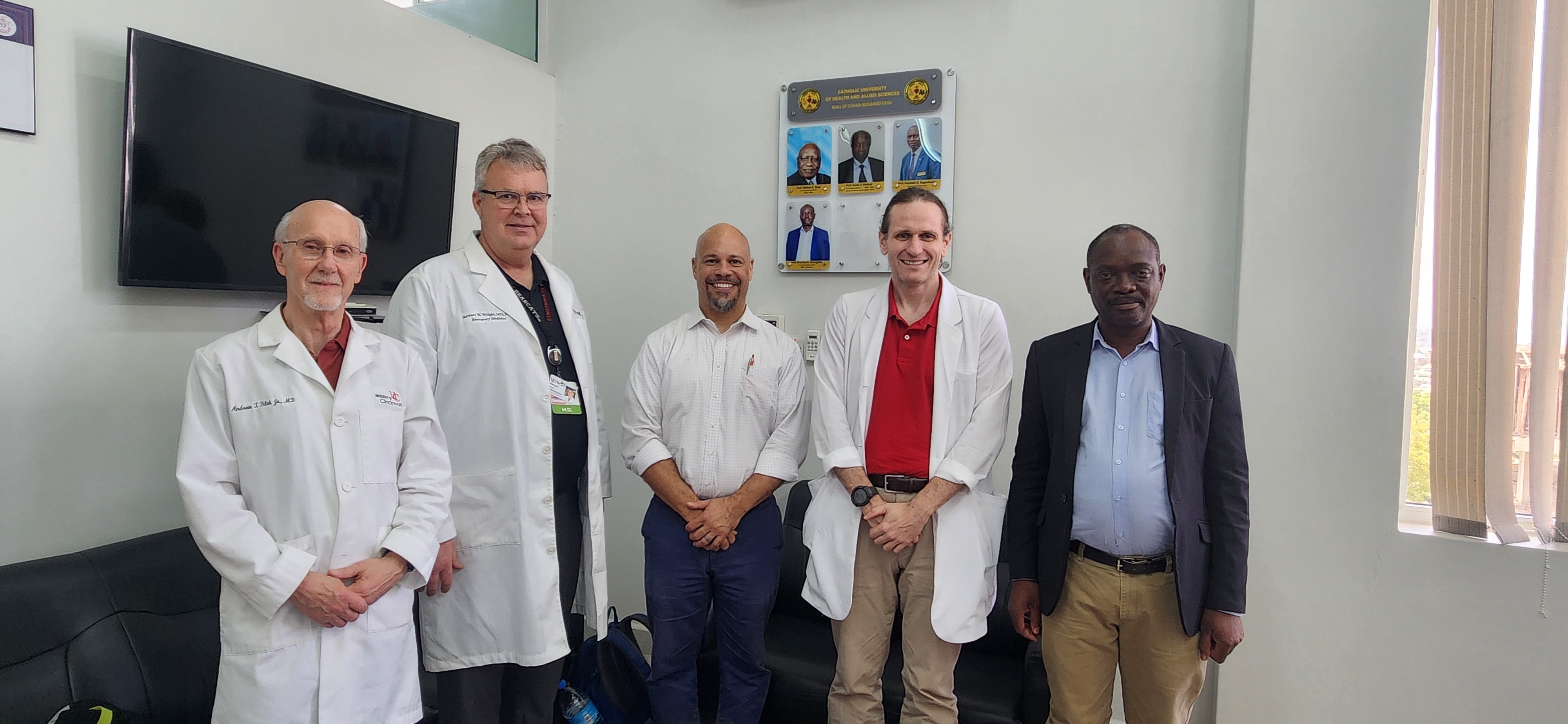 LtoR Andy Filak UC College of Medicine, Dean Emeritus, with UC physicians, Stewart Wright, M.D., Chris Lewis, MD, Joey Fixler, MD, with Erasmus Kamugisha, MD, Vice Chancellor of UC's partner institution, the Catholic University of Health and Allied Sciences, Tanzania. Photo/Village Life