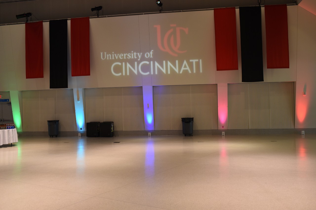 Multicolor lights shine upwards along a banquet room wall.