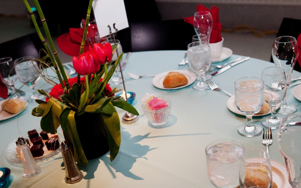 Round banquet table with place settings and floral decoration