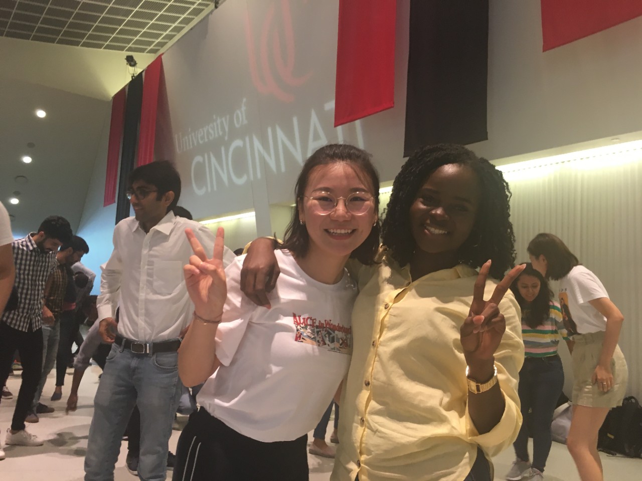 Two international students smile at international orientation.