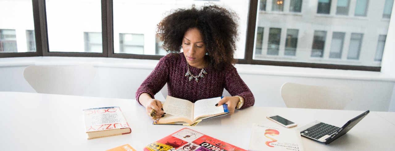 Person reading at table