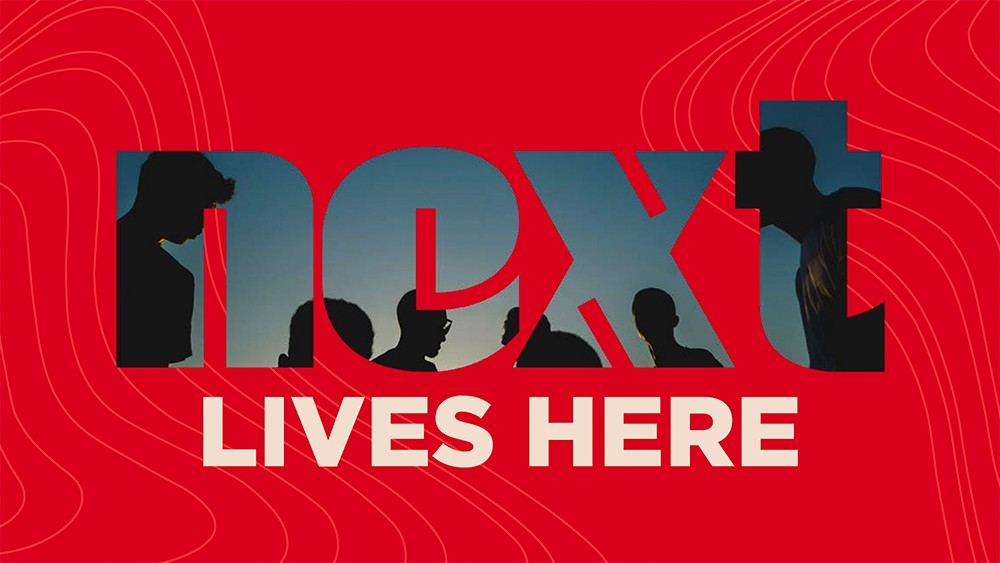 "Next Lives Here" text on a red background