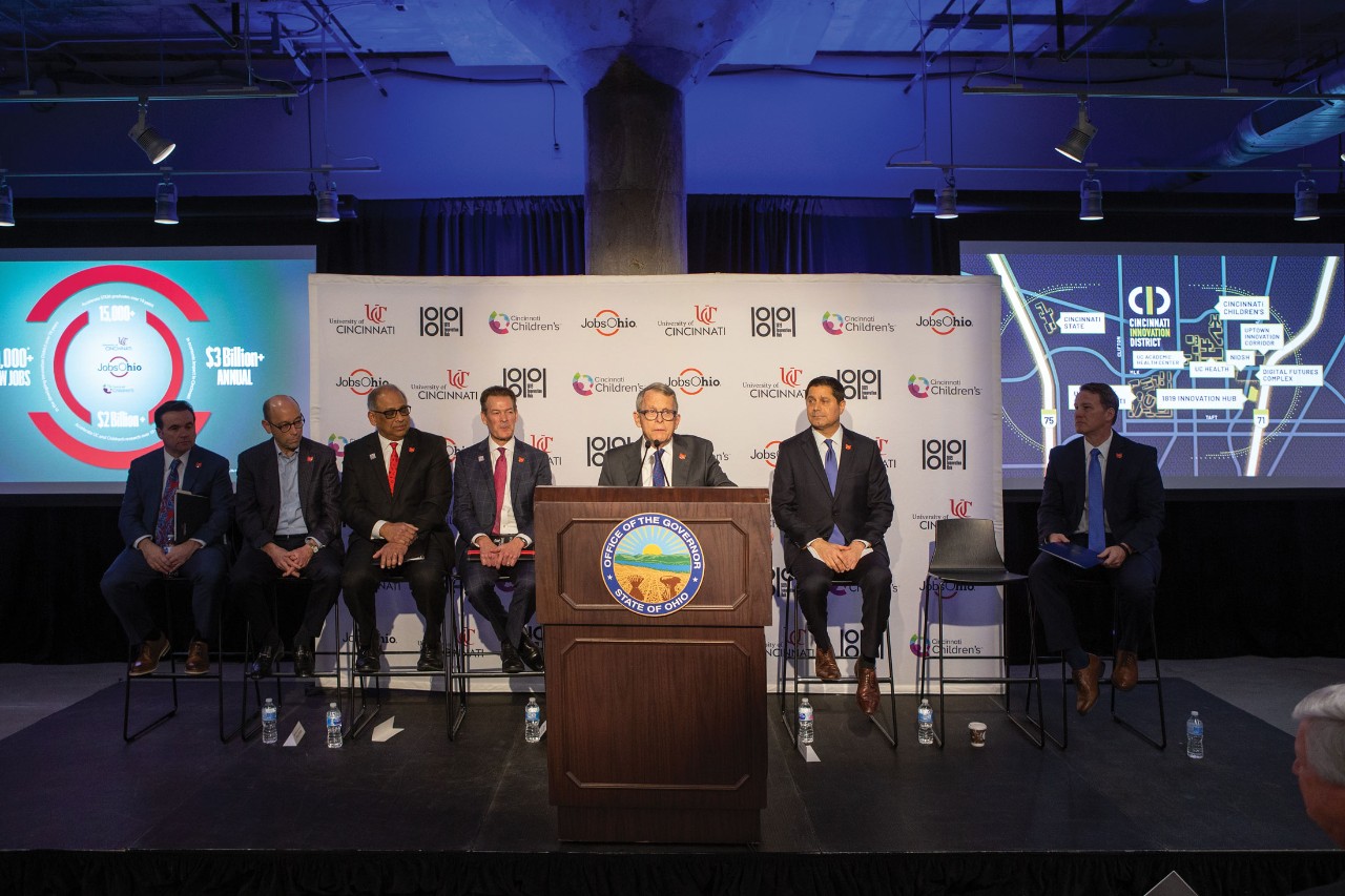 A premie holds the pinkie finger of a parent's hand