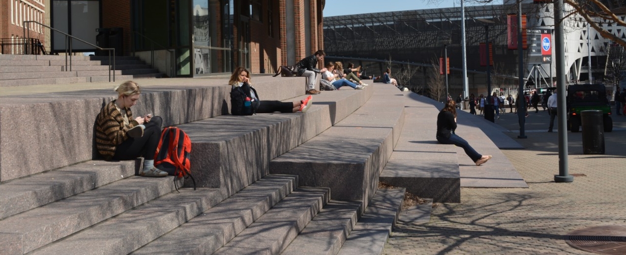 Students sit on the steps in front of Steger Student Life Center.