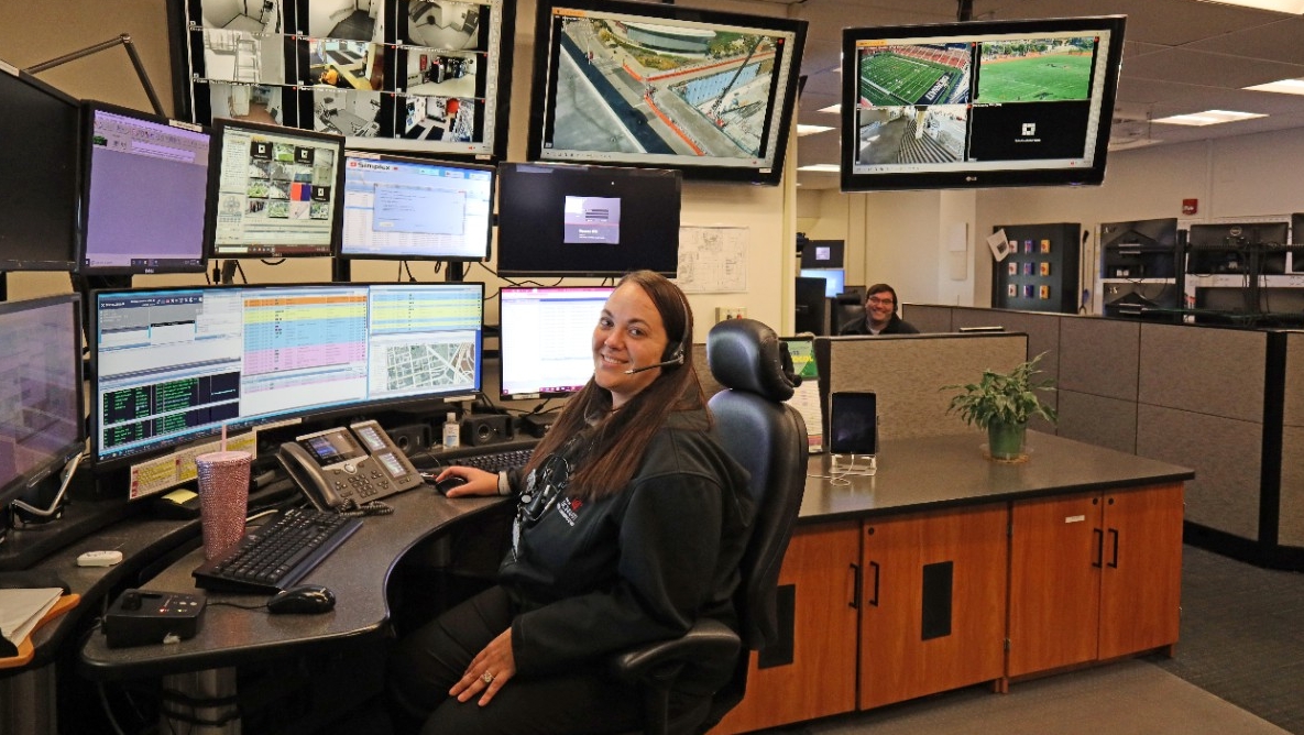 A dispatcher monitors multiple screens in UC's 911 Communications Center.