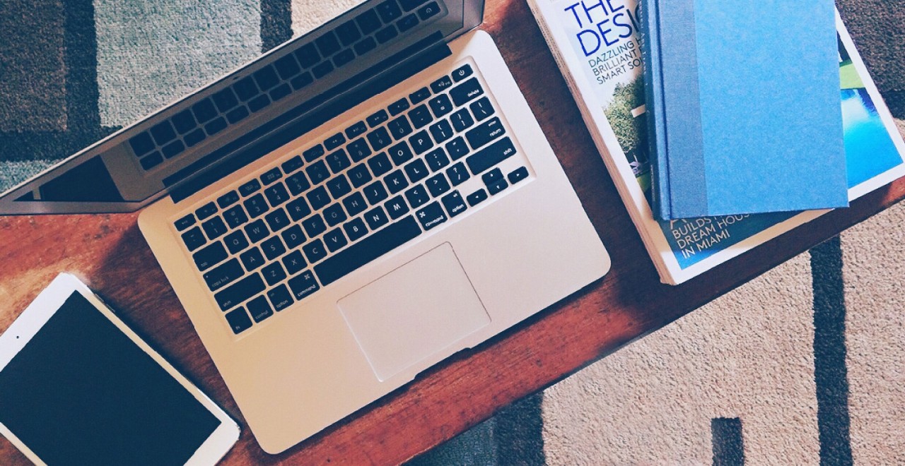 laptop computer, ipad and books on a table
