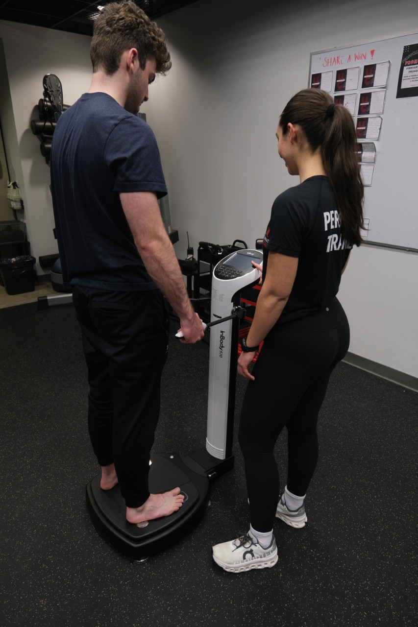 image of two people using a body comp machine