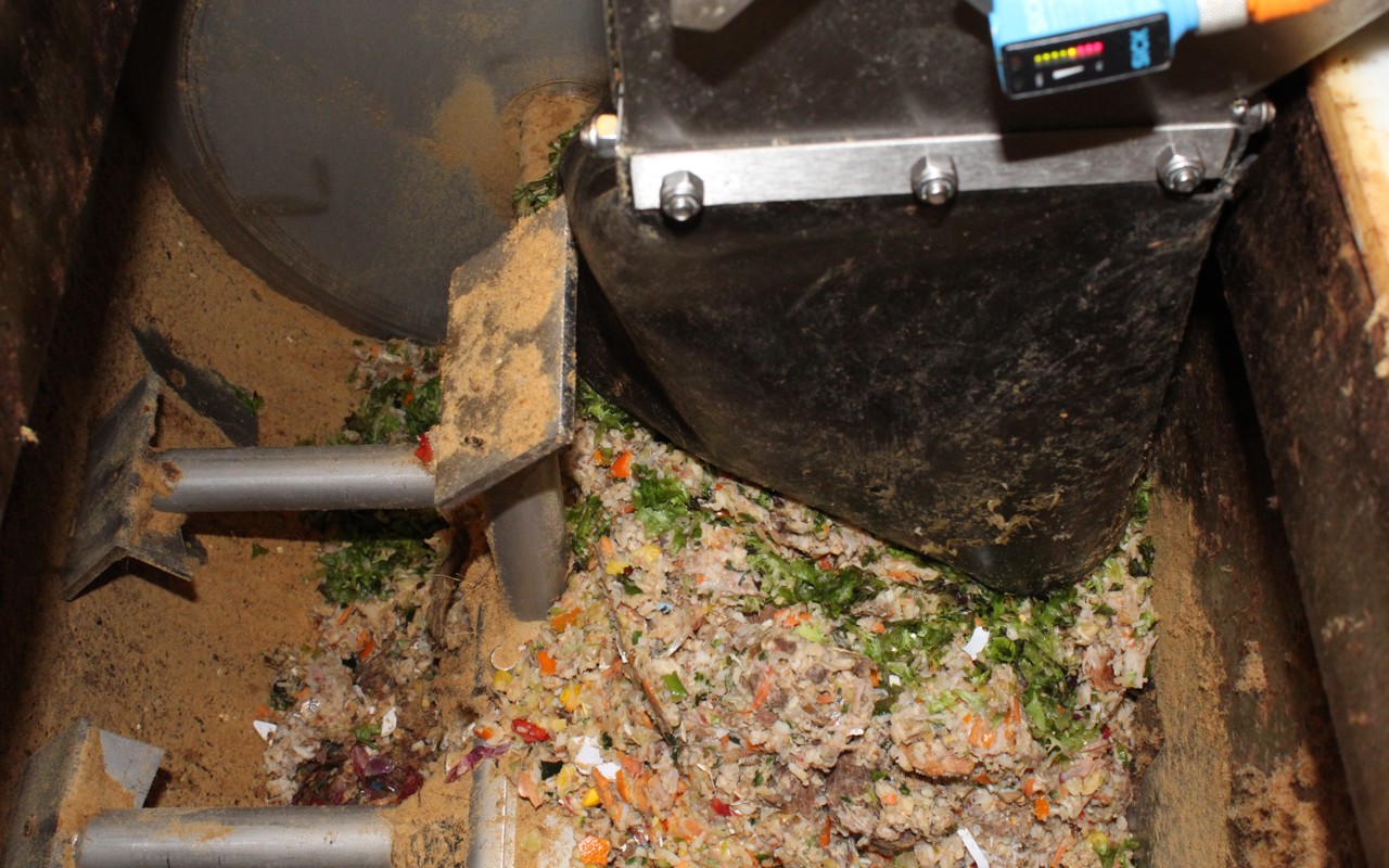 An overhead view of food waste being processed inside the food dehydrator.