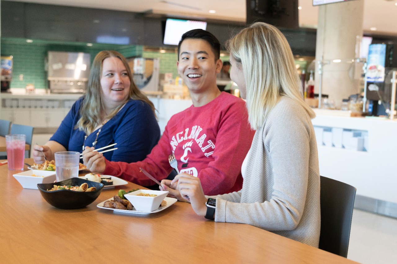 Two male students talking in dining center