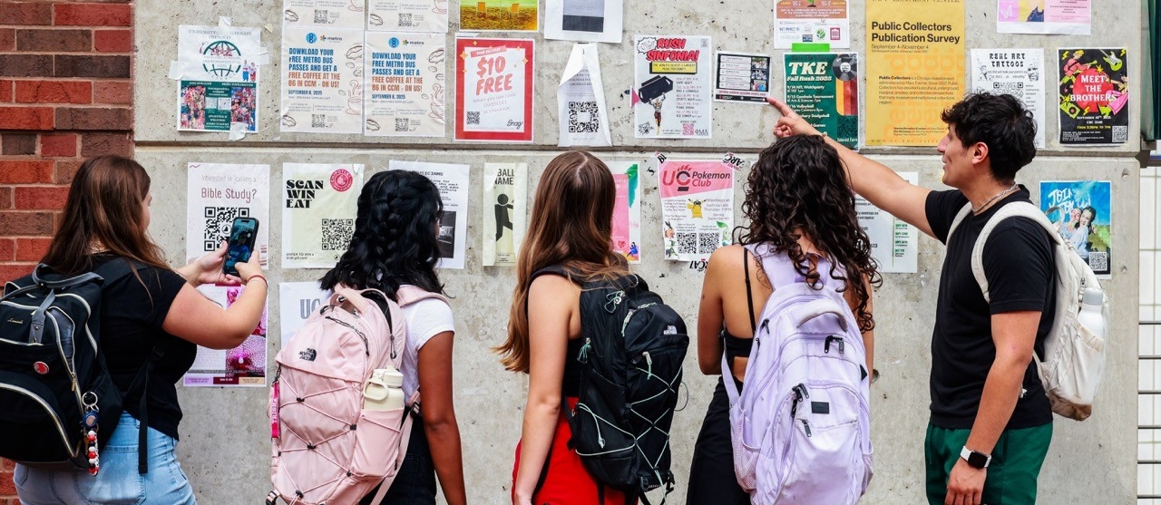 Students looking at a bulletin board on campus