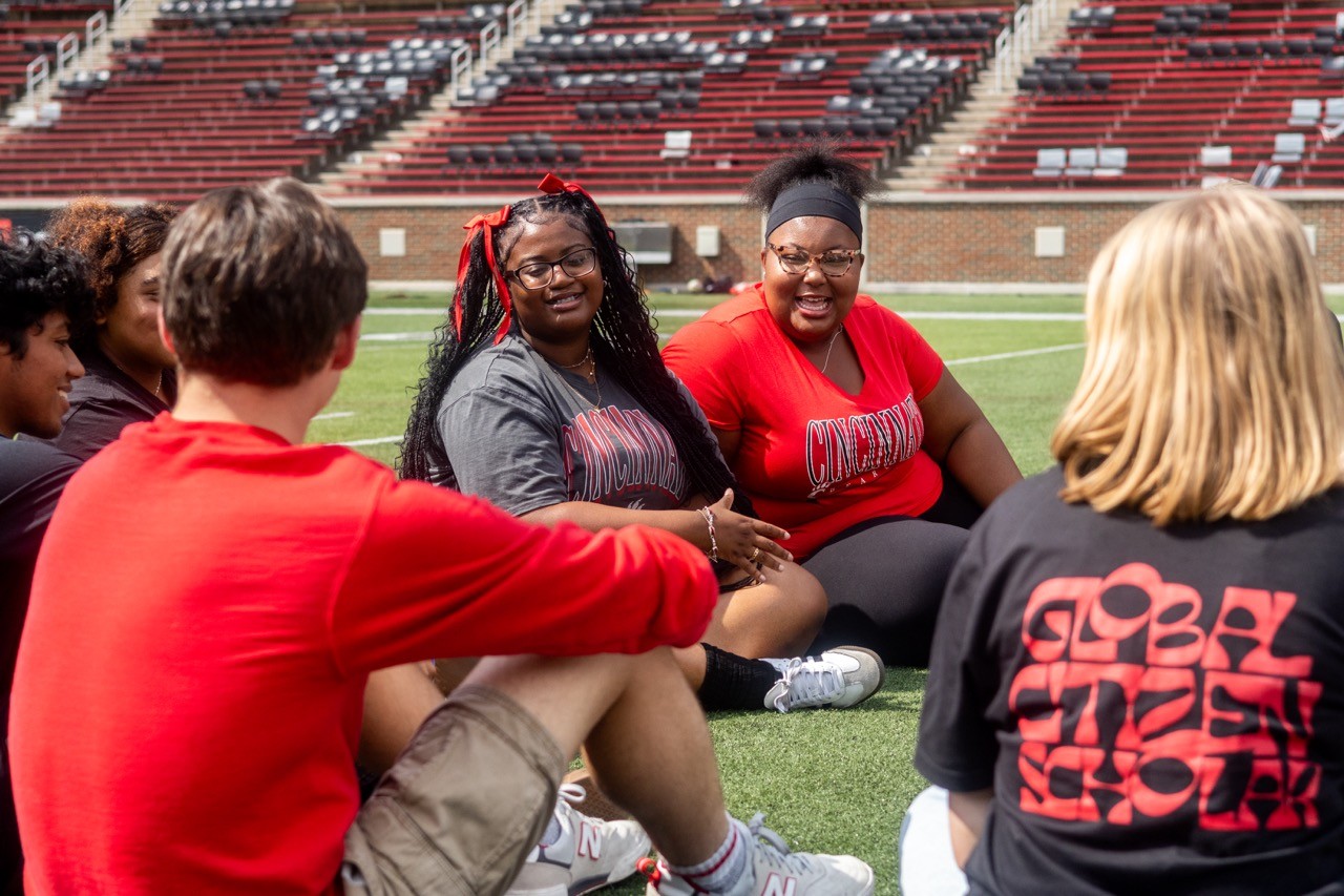 Students sitting in a circle in Nippert stadium