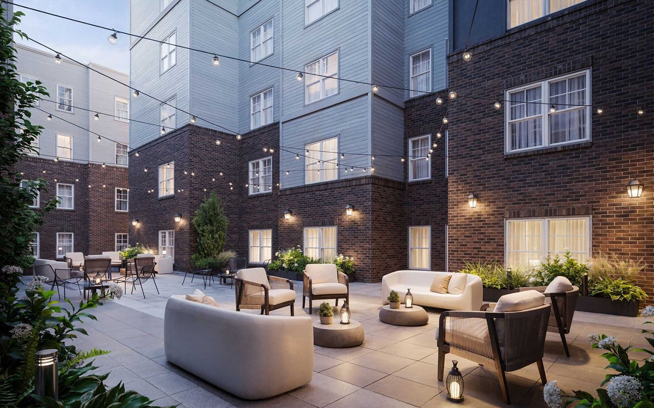 Courtyard featuring string lights and lounge furniture