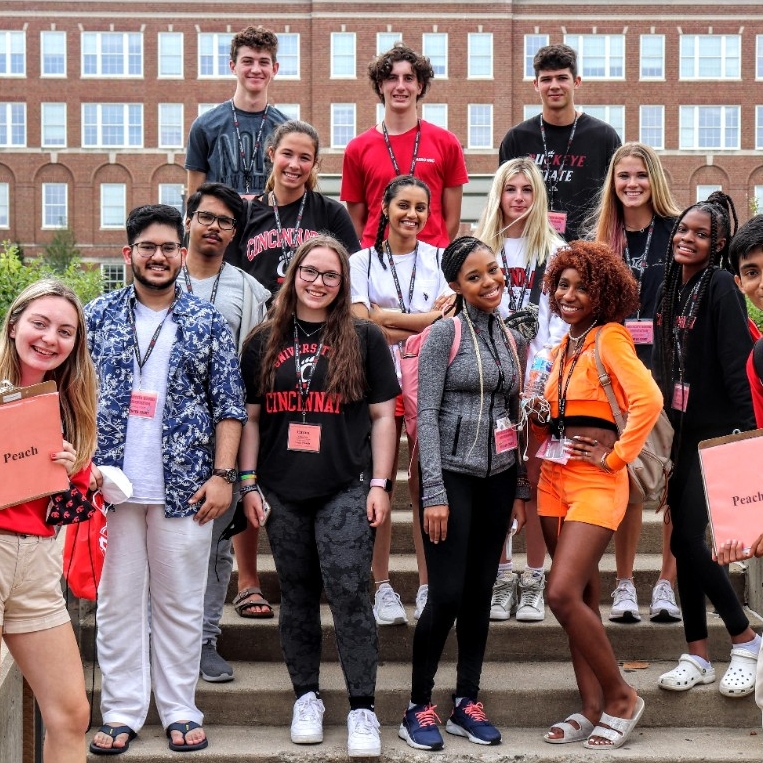 Group of students and Student Orientation Leaders posing in front of building
