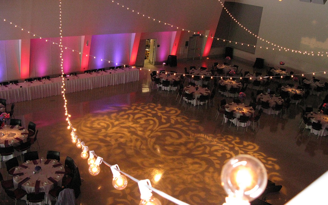 Great Hall is set up with an elegant lighted dance floor, round tables and party lights