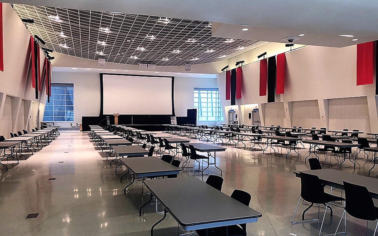 Floor level view of fair set-up with tables and chairs.