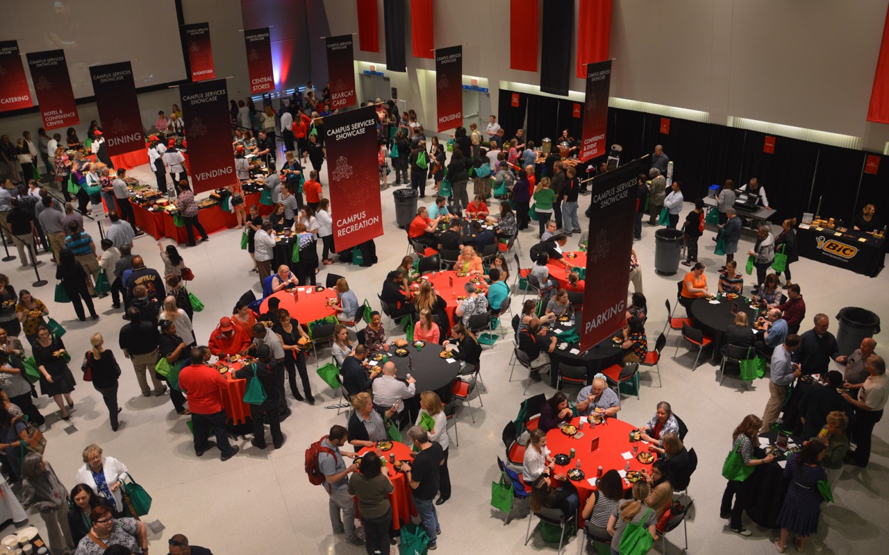 Overhead view of people eating at high top tables and seated, and tables on the perimeter