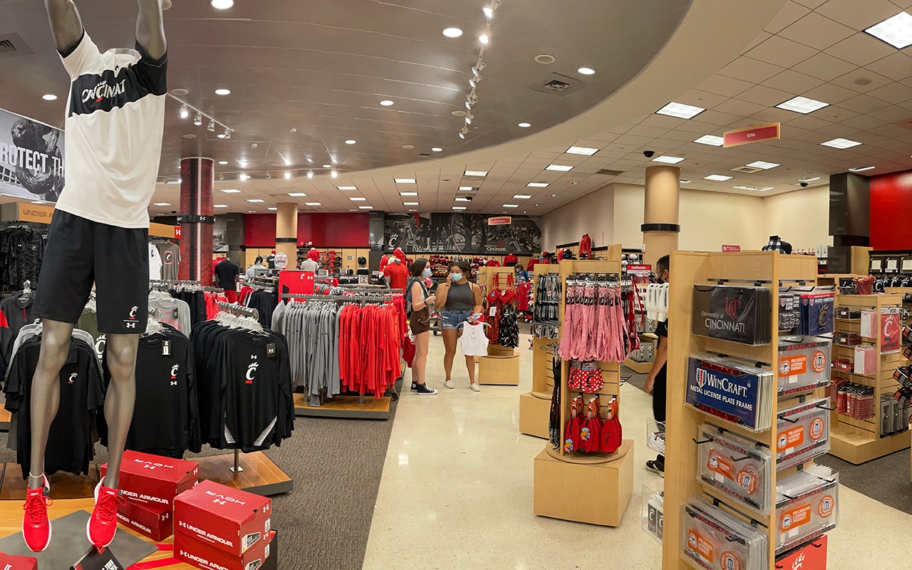 A baskeball player mannequin and several racks of clothing and gifts in the bookstore
