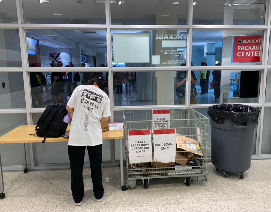 Student unpacking a box in the package center