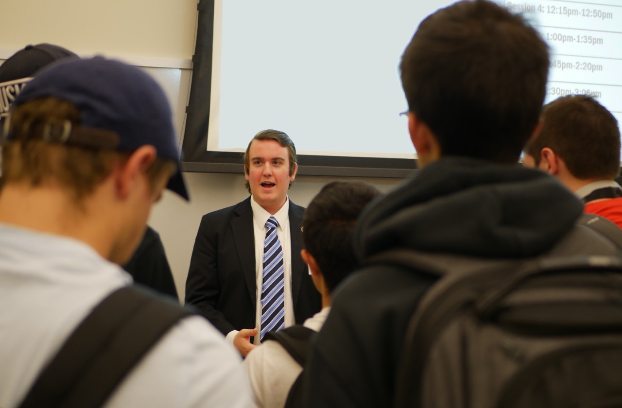 industry rep talks to students at event. 