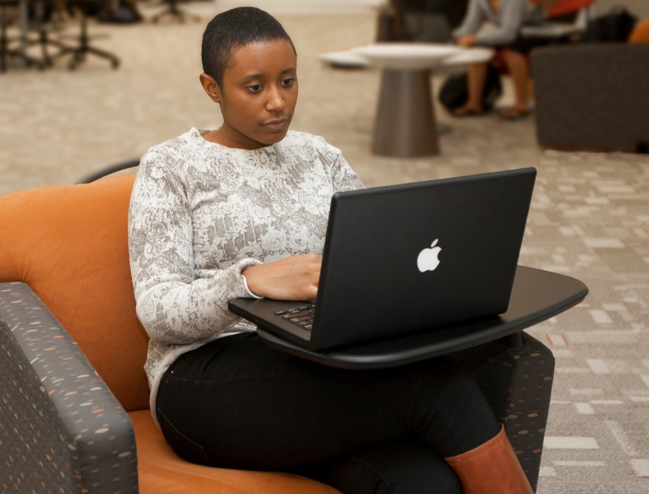student working on lap top in learning center