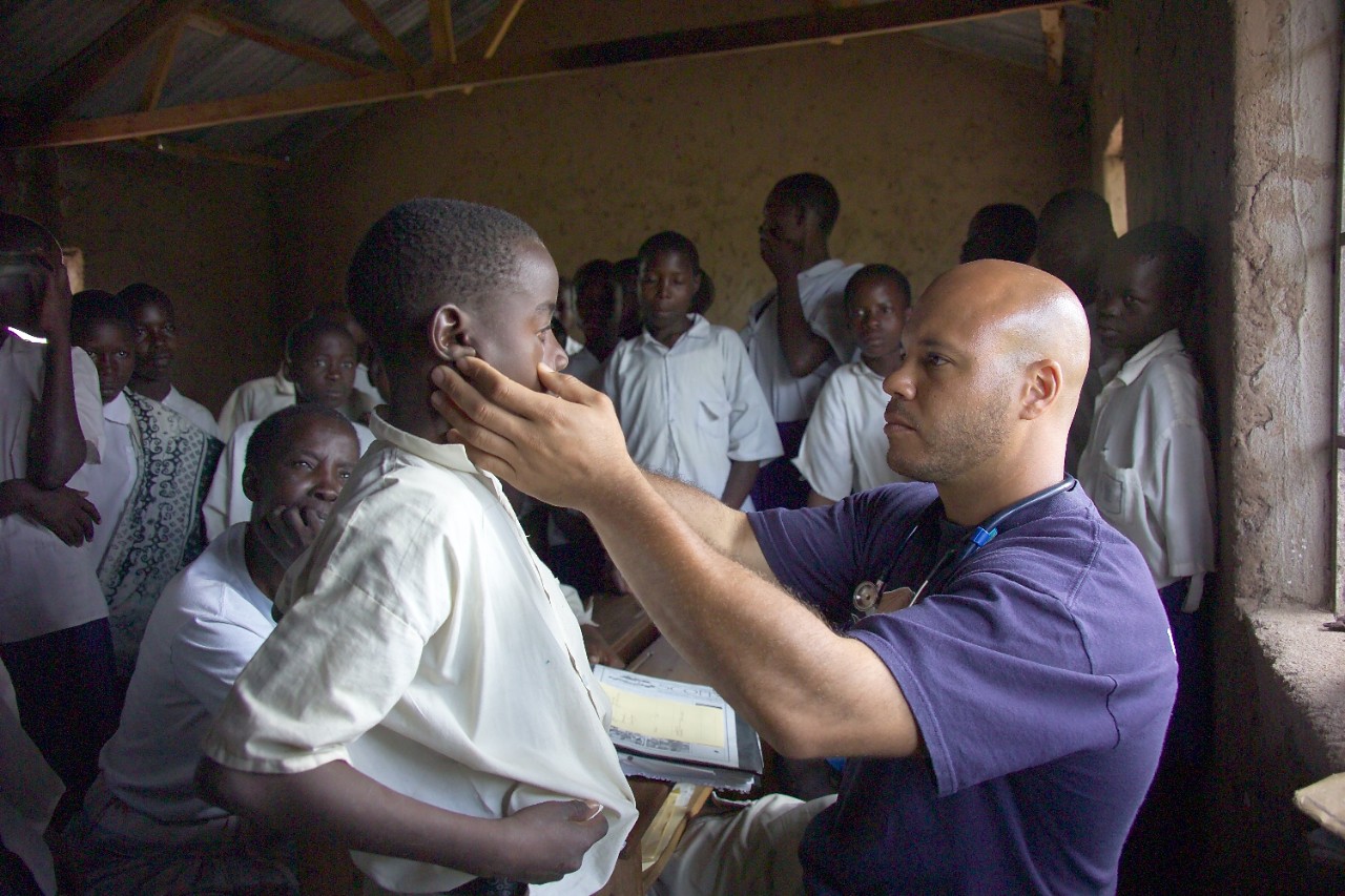 Chris Lewis, MD,  shown with patient in Tanzania.