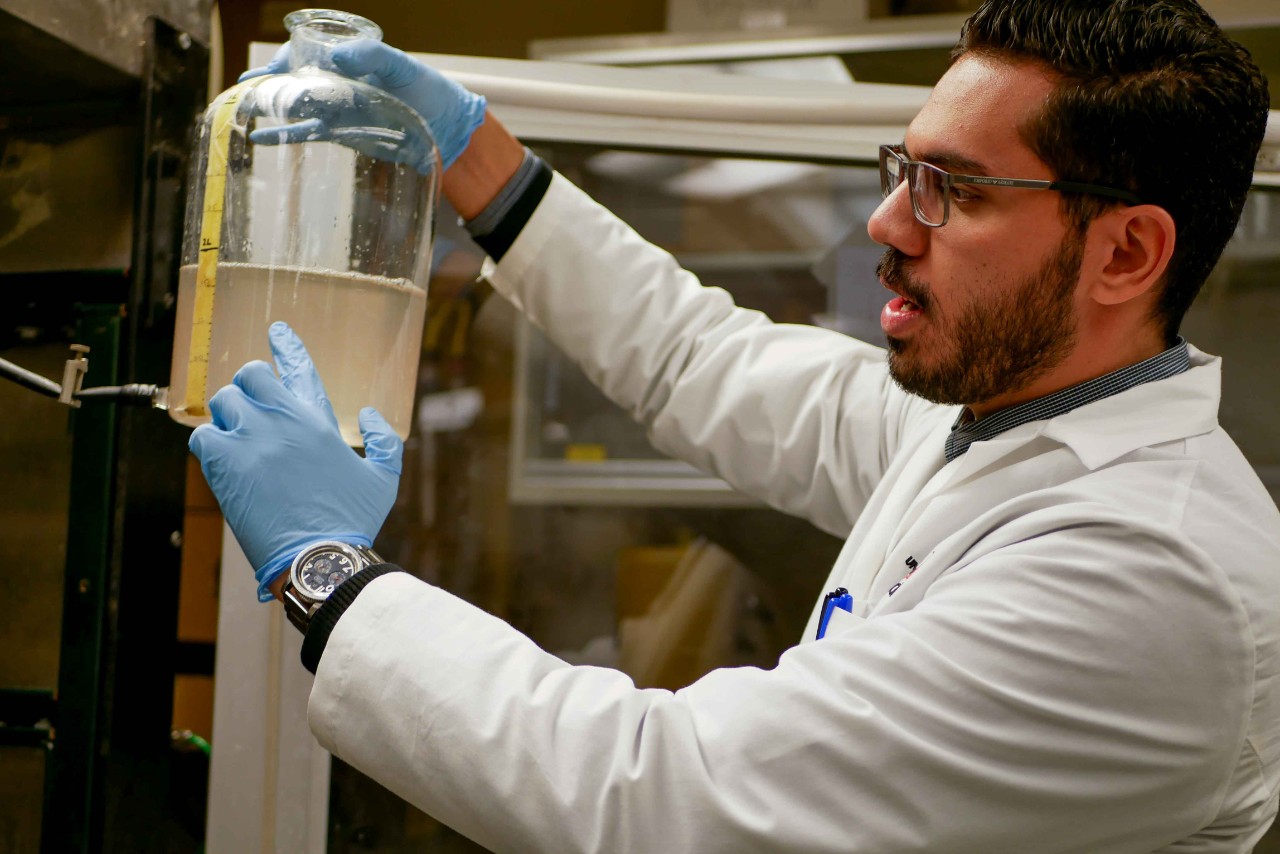 Dewidar holds up a jug of water