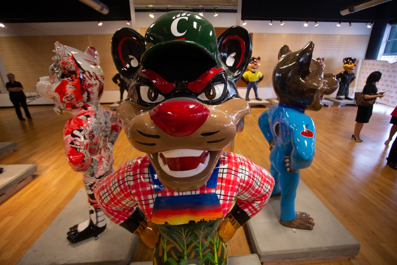 Frontal view of a statue of a Bearcat decorated as a farmer