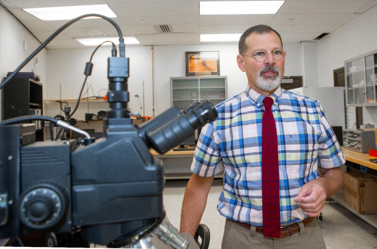 UC professor John Emmert, new director of National Science Foundation research lab shown here in his lab and Armstrong’s relief at Rhodes hall.  UC/Joseph Fuqua II