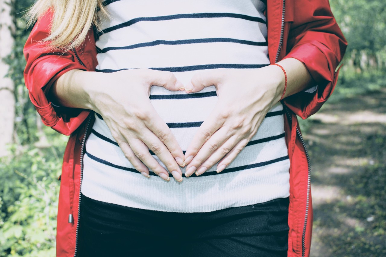 photo of women placing her hands on her stomach