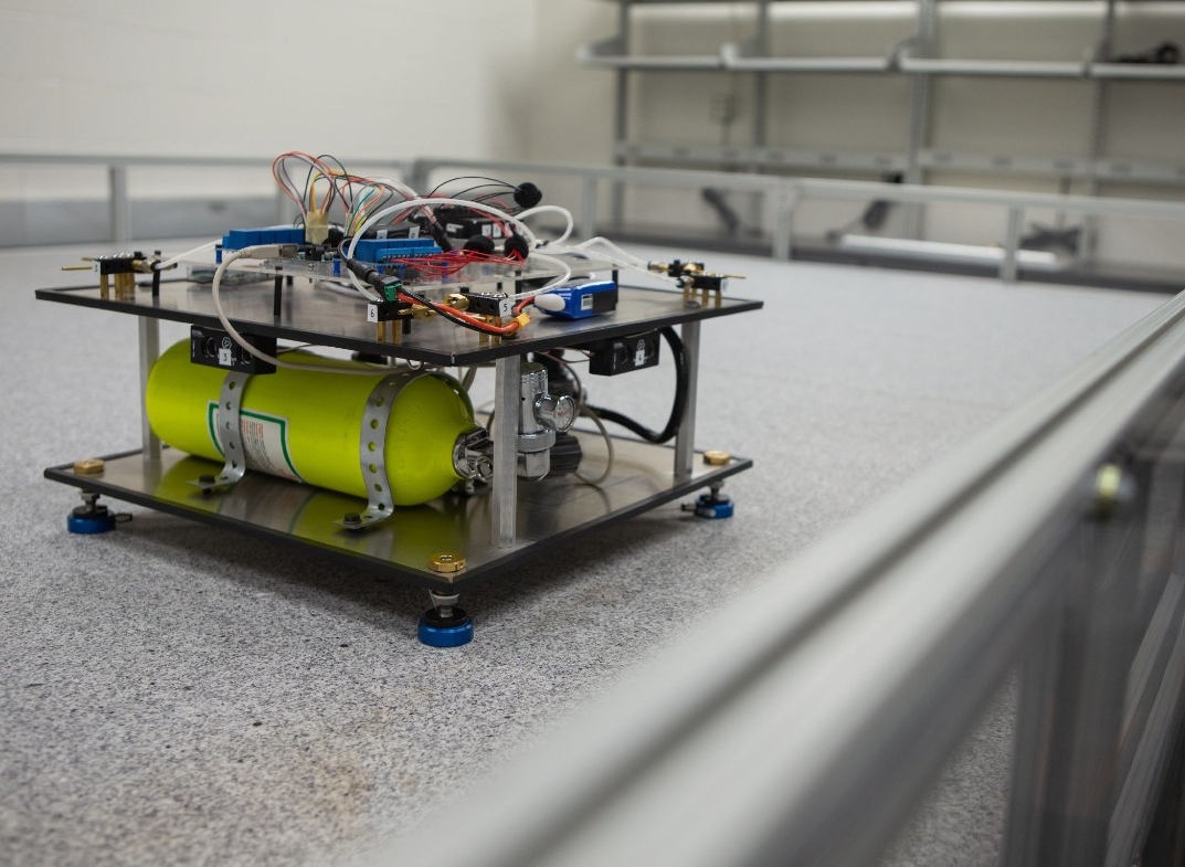 A shoebox sized robot on a table.