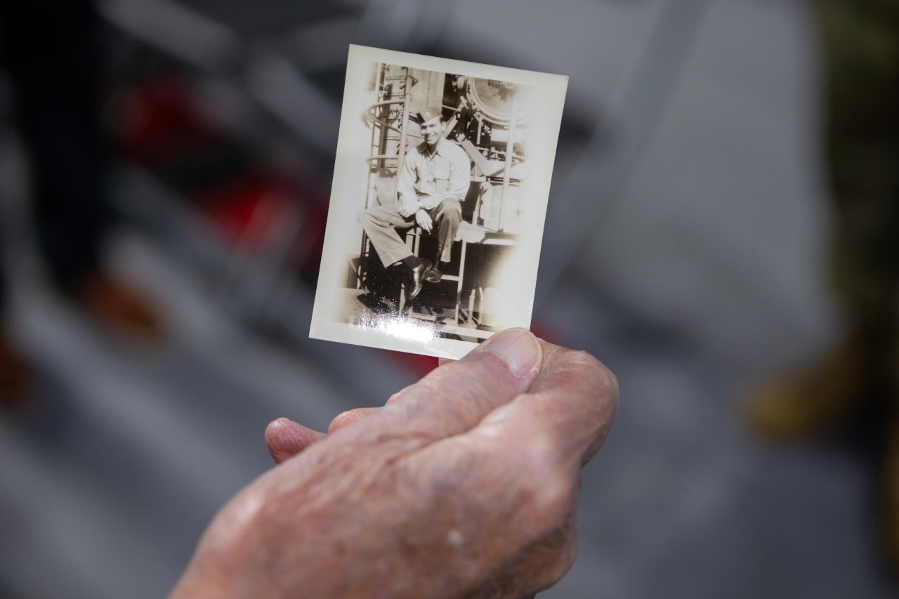 Paul Blom holds a photo of himself while in the Navy during World War II