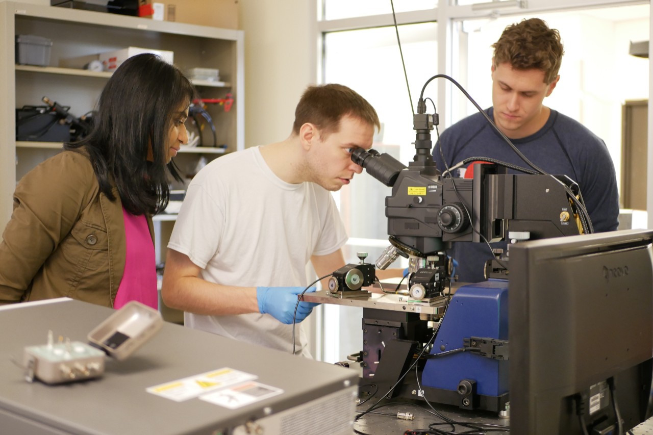 Rashmi Jha and her students use equipment in the lab