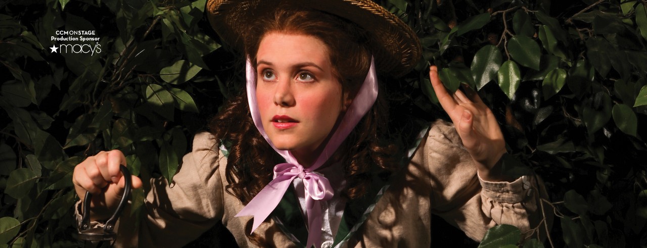 Young girl looking through trees to find a secret garden.