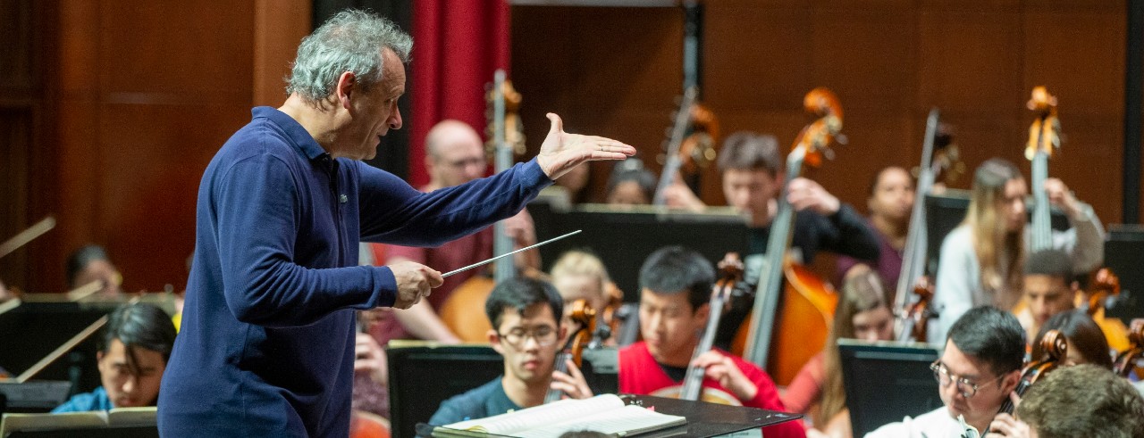 Louis Langree conducts a student orchestra in a rehearsal