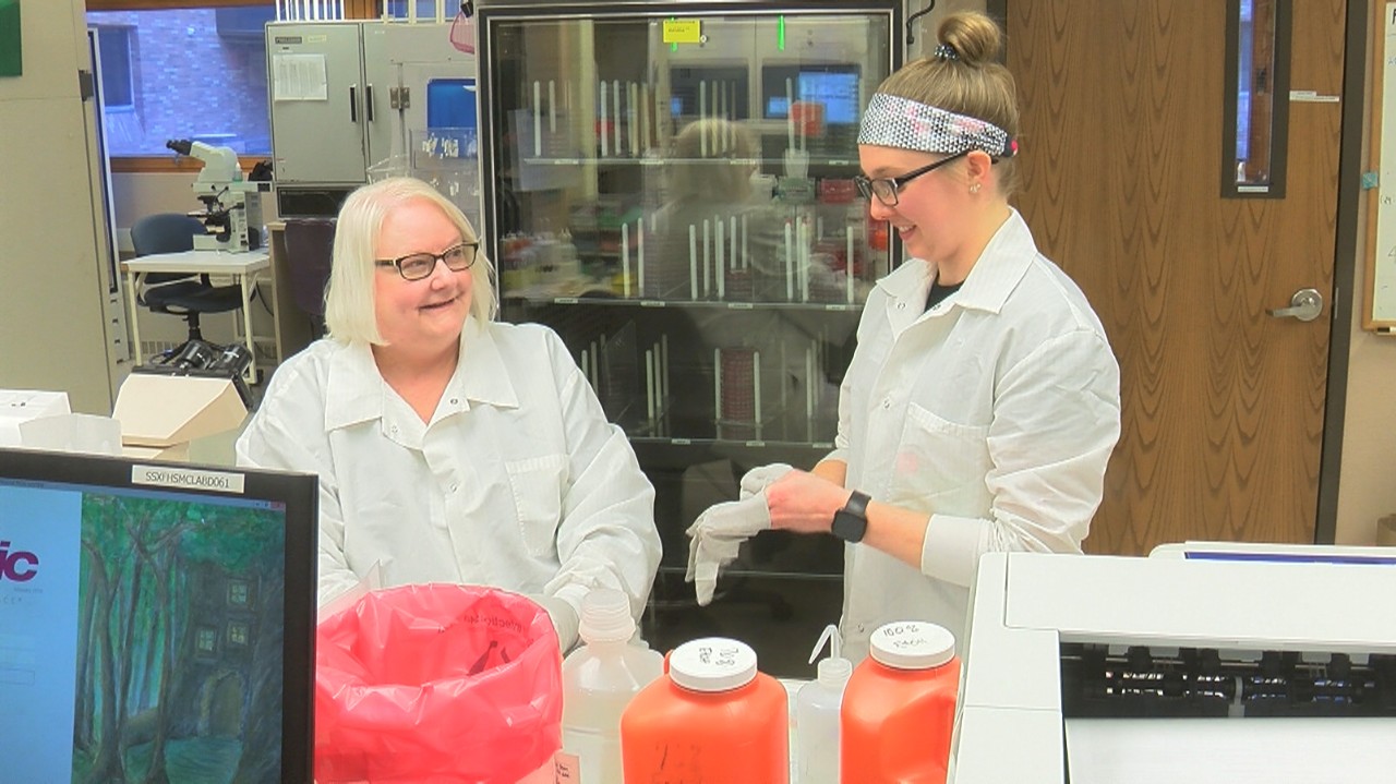 Two women in lab coats working in a medical lab