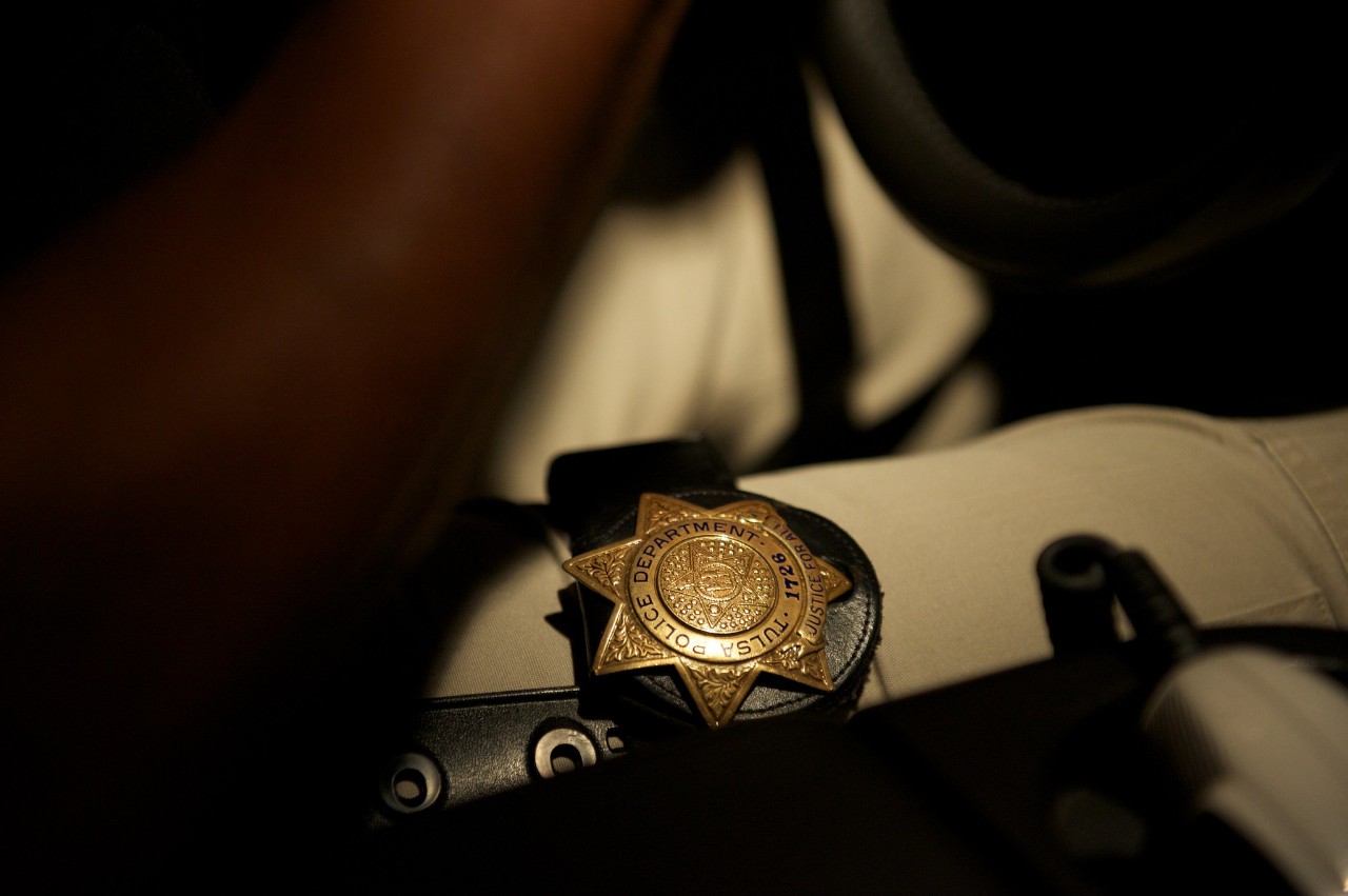 a police badge on a man's leg