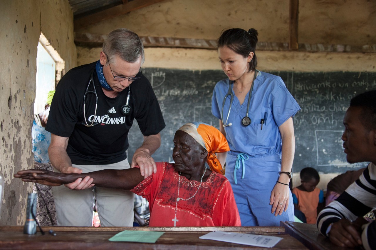 Dr. Art Pancioli and med student Katie Brown help a patient in Tanzania.