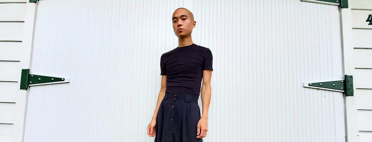 Eddy Kwon stands in front of a white door