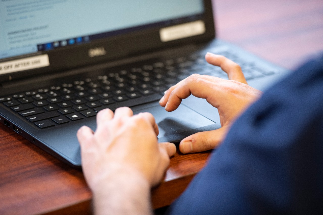 a students writing on a laptop about social justice