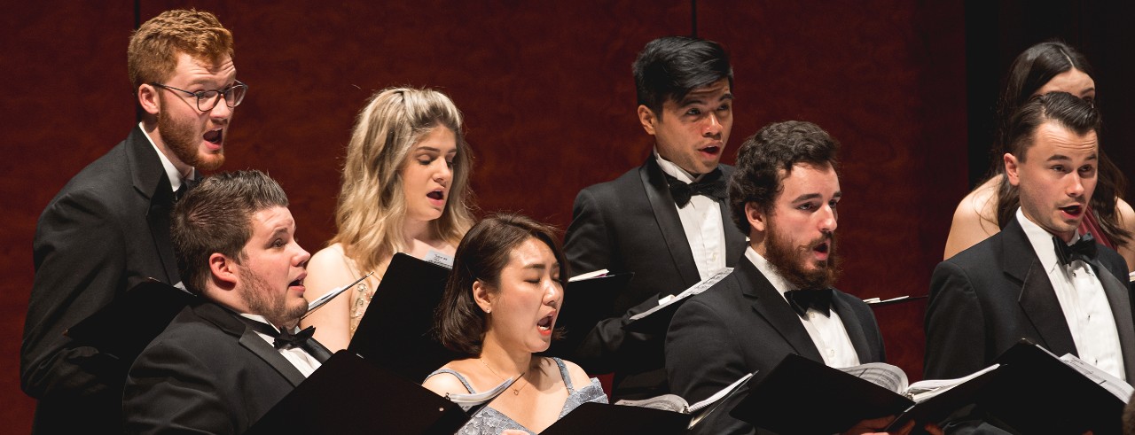 A choir performs on stage