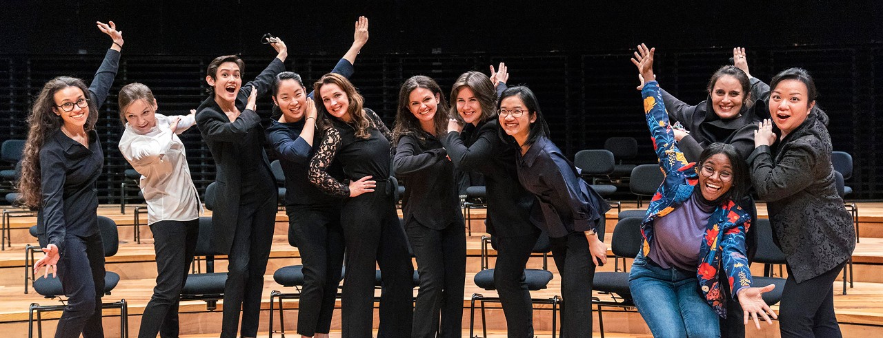 Women of the La Maestra competition celebrate with a pose for the camera 