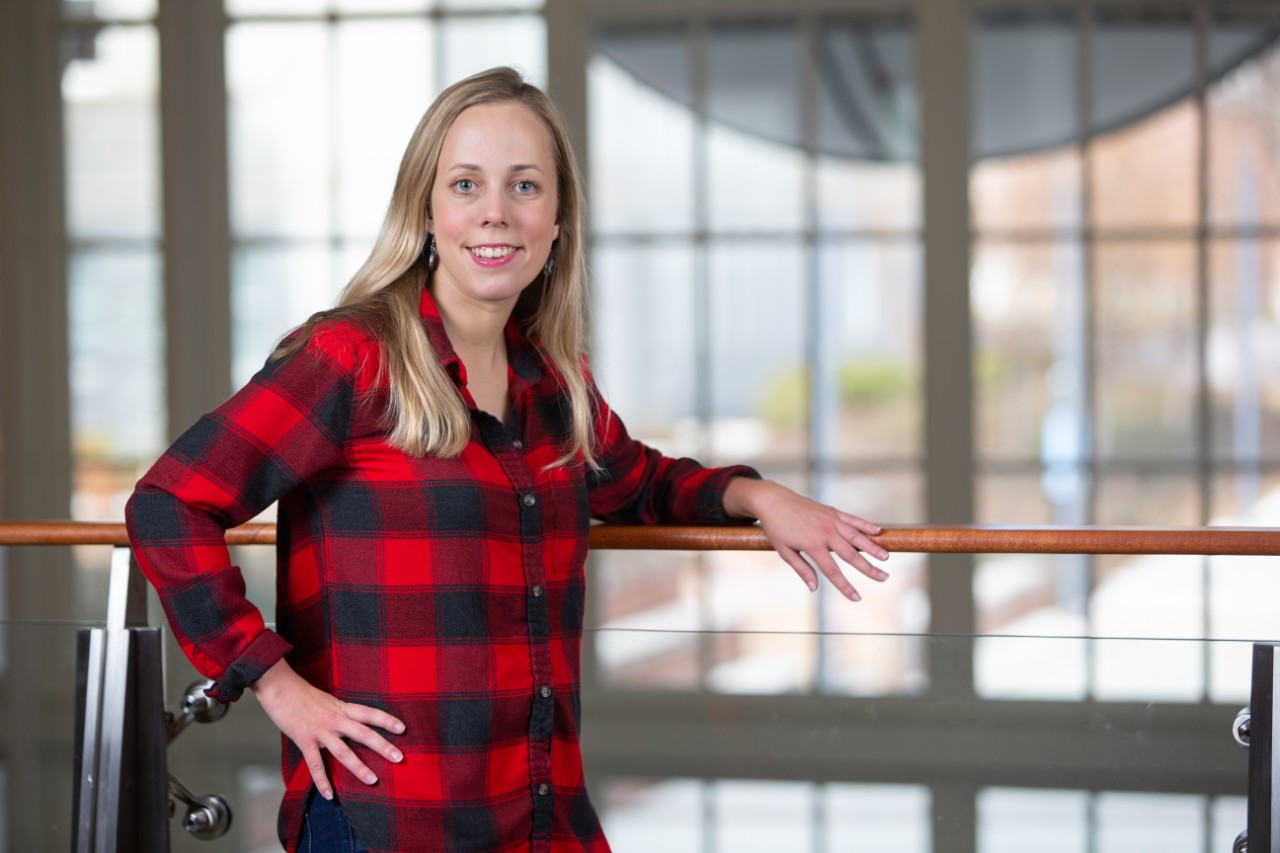 Woman in red and black shirt smiling